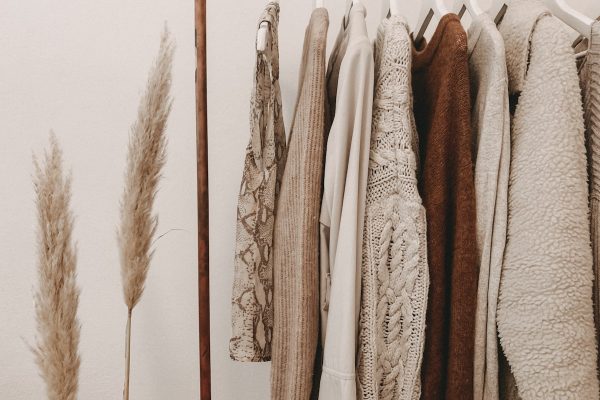 Curated vintage clothing rail featuring pre-loved designer silk and wool garments