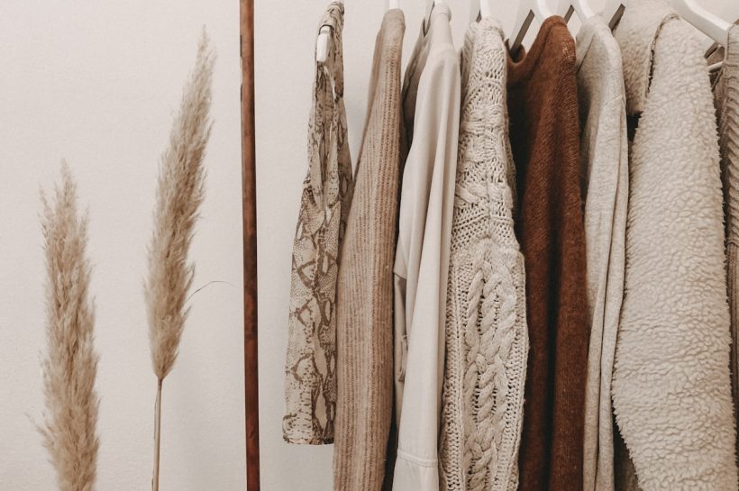 Curated vintage clothing rail featuring pre-loved designer silk and wool garments