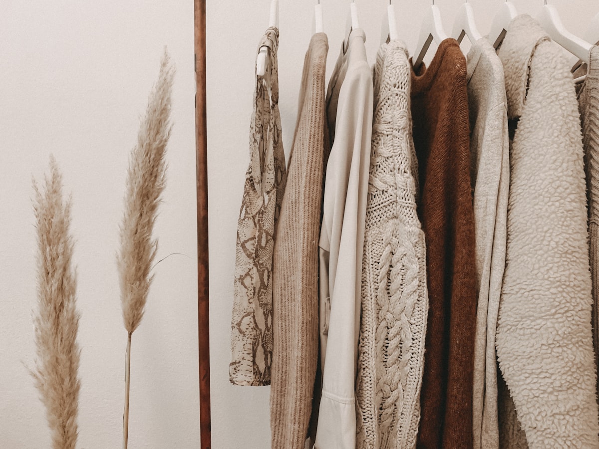 Curated vintage clothing rail featuring pre-loved designer silk and wool garments
