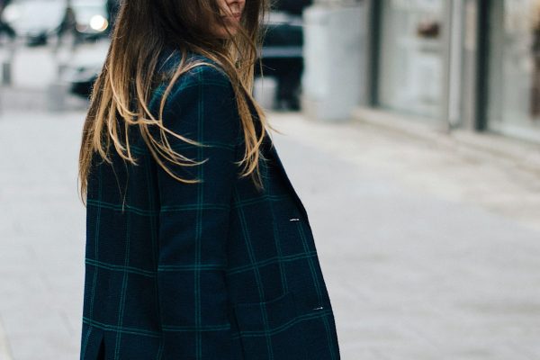 Contemporary relaxed monochromatic power suit styling on stylish professional woman