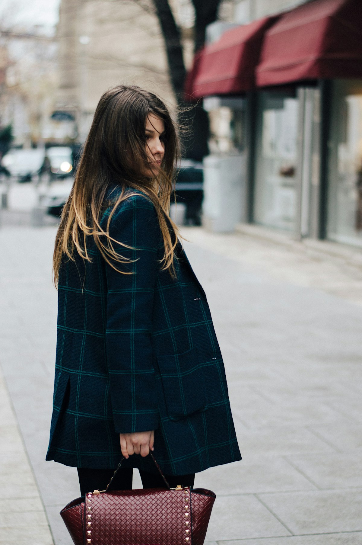 Contemporary relaxed monochromatic power suit styling on stylish professional woman