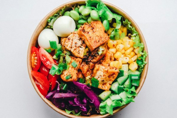 Mindfully prepared colorful quinoa avocado vegetable salad bowl in quiet natural setting