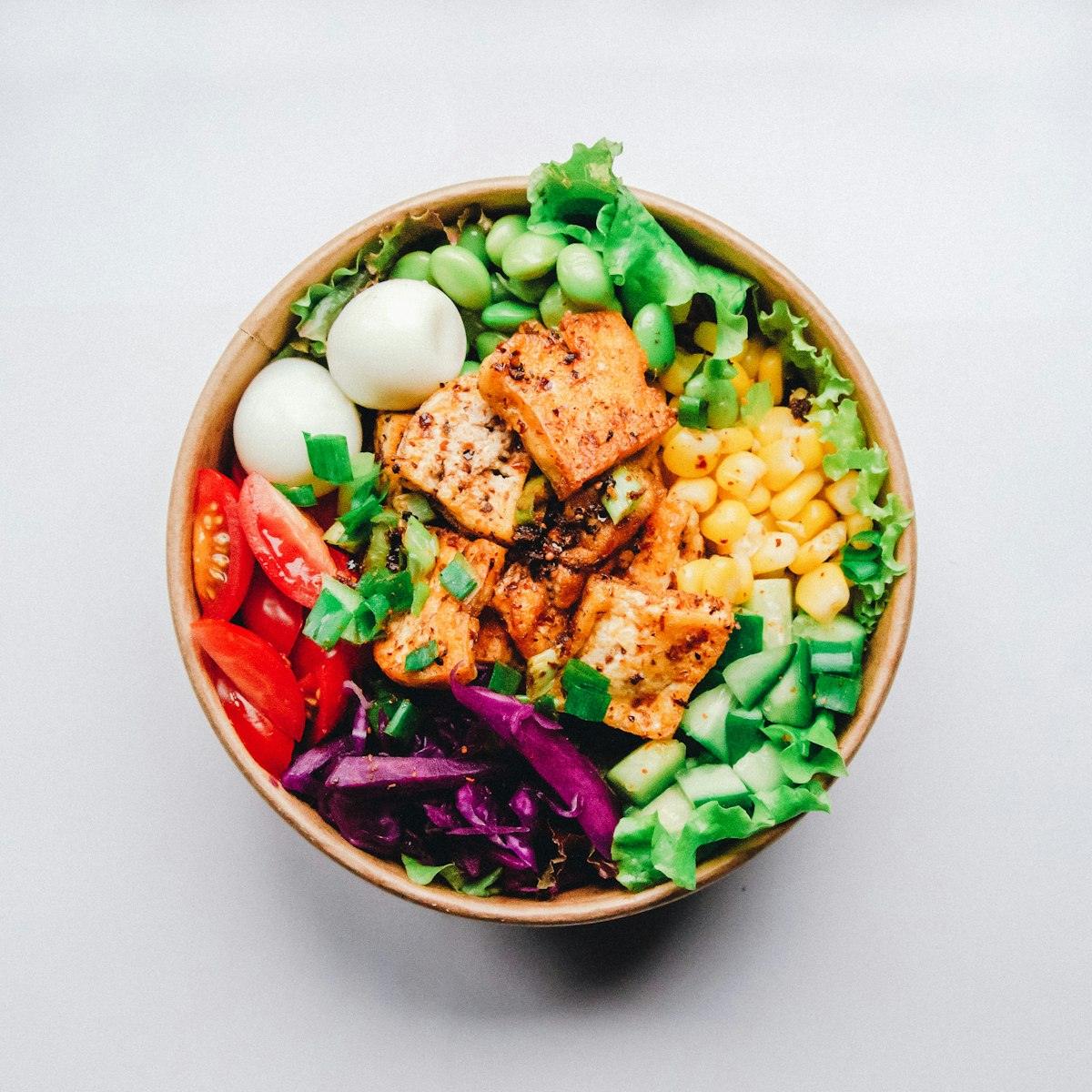Mindfully prepared colorful quinoa avocado vegetable salad bowl in quiet natural setting